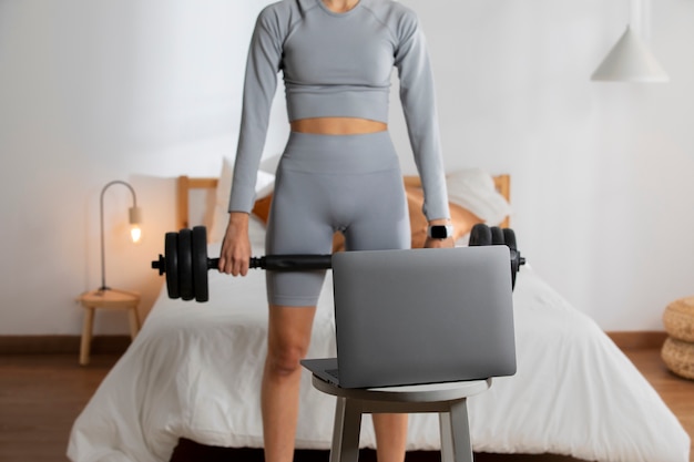 Adjustable dumbbells on a workout mat