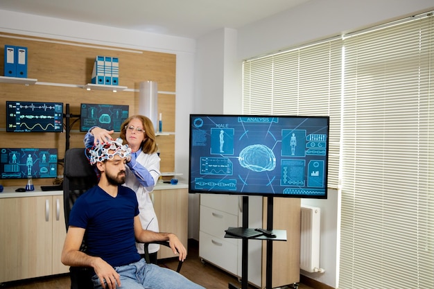 EEG cap and screen showing image sequences used in Fastball EEG test