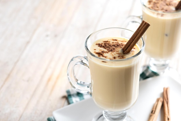 Warm clove milk in a mug, garnished with cloves