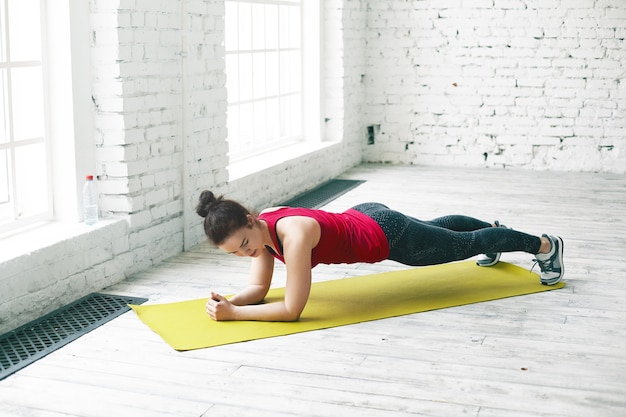 Woman performing a modified plank on knees