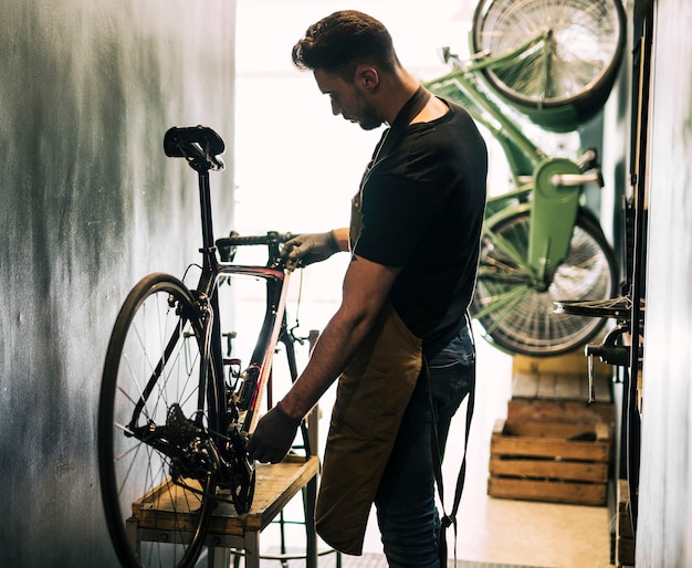 Close-up of a cyclist adjusting saddle height and handlebar position
