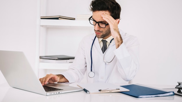 Exhausted doctor sitting in a break room