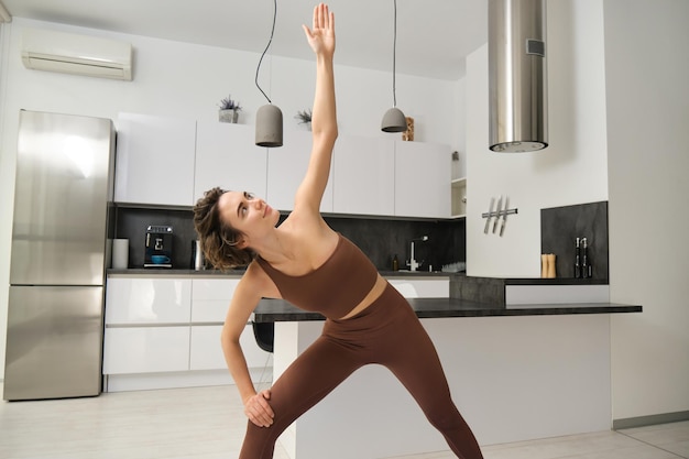 Person performing dynamic stretches in living room