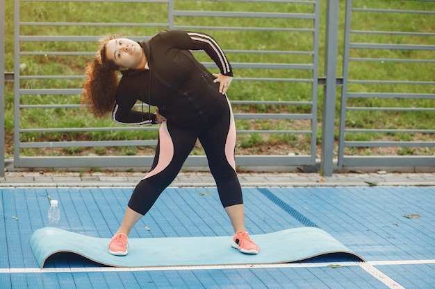 Woman performing gentle arm circles and leg lifts