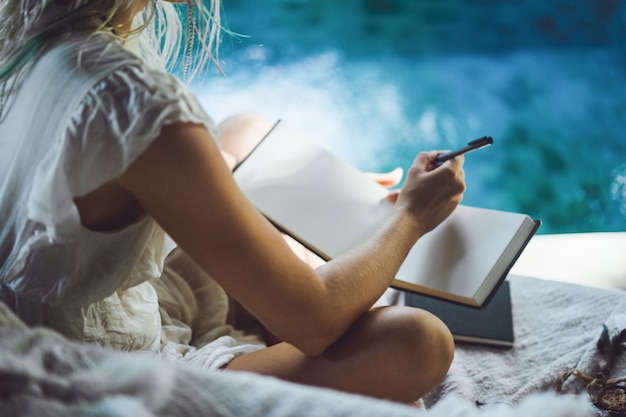 Man journaling in the evening with a cup of tea