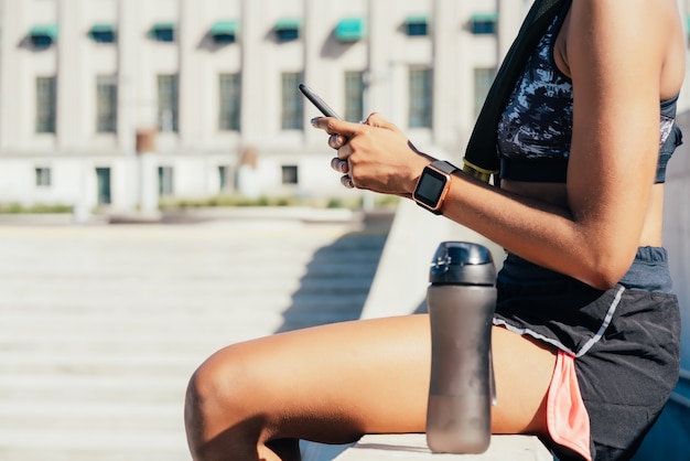 Smart water bottle and fitness tracker on poolside