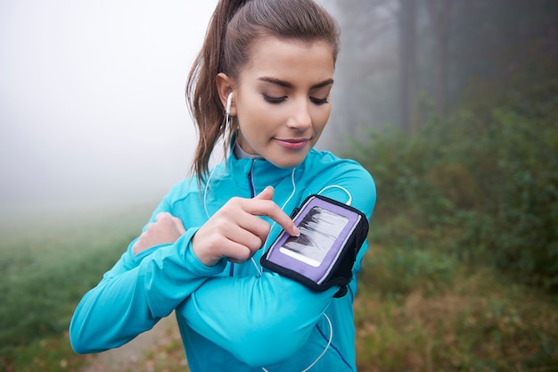 Person checking fitness tracker data on wrist