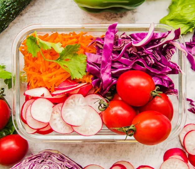 Colorful meal prep containers with vegetables, lean protein, and whole grains