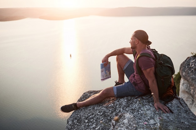 Traveler meditating at sunrise