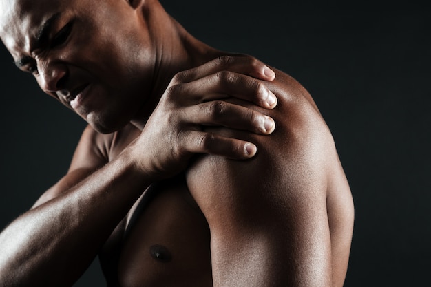 Athlete recovering with protein shake and stretching