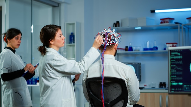 Scientists working in a neuroscience lab with brain scans