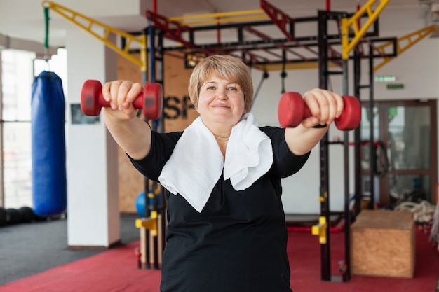Senior performing a modified kettlebell swing with proper form