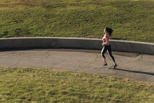 Runner on a trail during sunrise