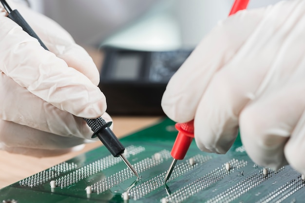 Engineer using a test jig on a printed circuit board
