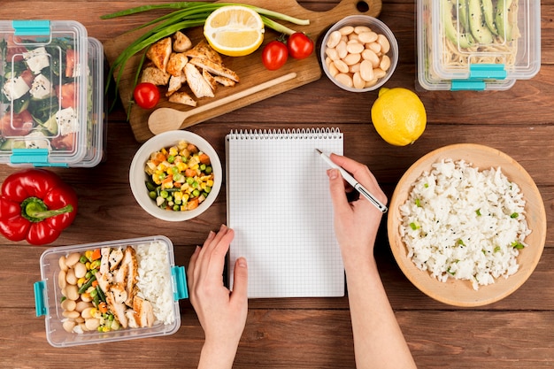 Person organizing meal prep containers