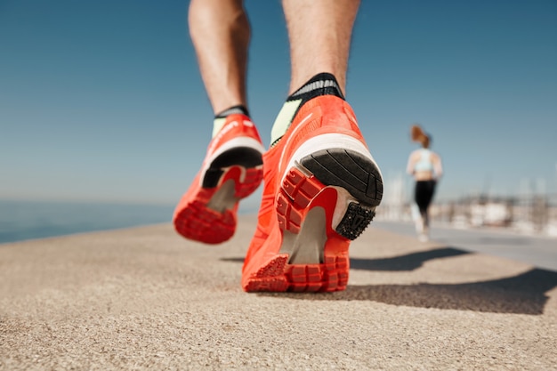 Pair of well-worn running shoes next to a new pair