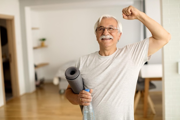 Senior man doing morning stretches at home