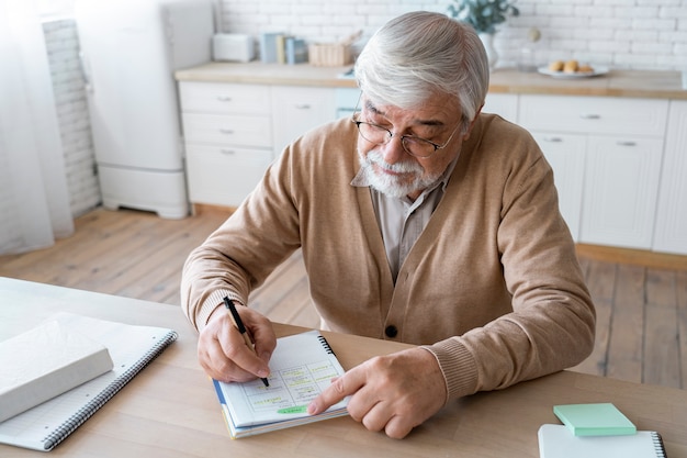 Senior writing in a health journal