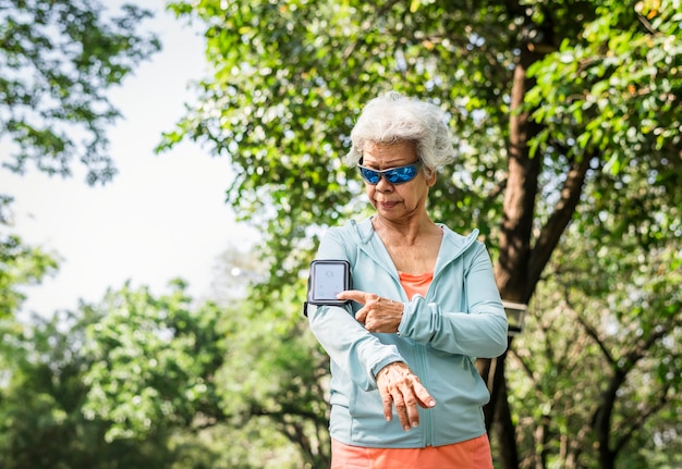 Senior checking step count on a fitness tracker