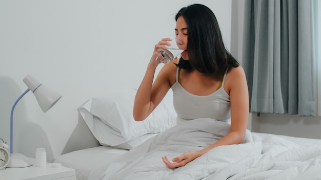 Glass of water and a peaceful bedroom setup