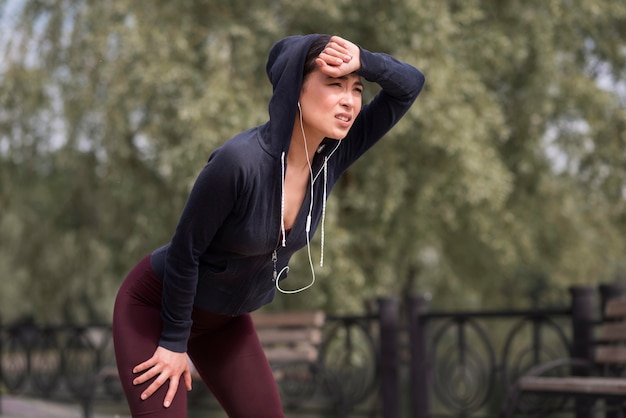 New mom jogging in a park during sunrise