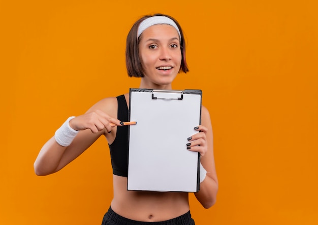 Teen tracking workout in a journal