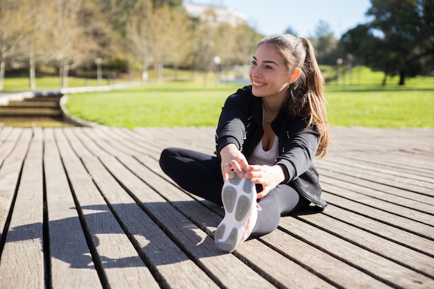 Teen doing flexibility exercises outdoors
