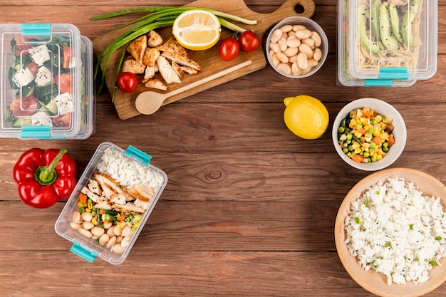 A person organizing meal containers in the fridge