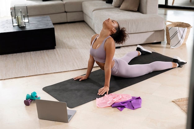 Office worker stretching on a yoga mat near desk